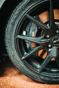 Close-up of a car wheel with brake components, promoting brake repair near me in Denver by AutoFordable Mobile Mechanics, with text overlays for booking diagnostics and free quotes, rated 4.81 stars from 80 reviews.