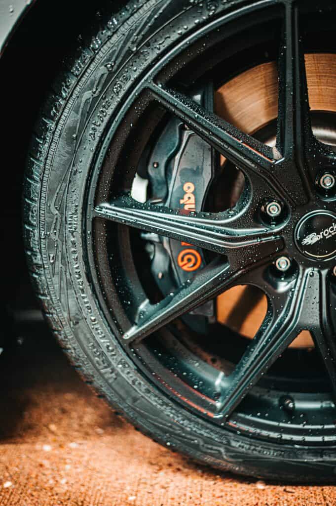 Close-up of a car wheel with brake components, promoting brake repair near me in Denver by AutoFordable Mobile Mechanics, with text overlays for booking diagnostics and free quotes, rated 4.81 stars from 80 reviews.