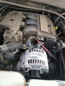 Close-up of an alternator in a vehicle engine during a mobile alternator repair in Fort Worth, TX by AutoFordable Mobile Mechanics, highlighting professional on-site car repair.