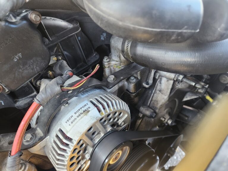 Close-up of an alternator in a vehicle engine compartment during a mobile alternator repair in Denver by AutoFordable Mobile Mechanics, showcasing expert car repair services.
