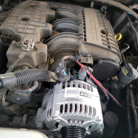 Close-up of an alternator in a vehicle engine during a mobile alternator repair in Fort Worth, TX by AutoFordable Mobile Mechanics, highlighting professional on-site car repair.